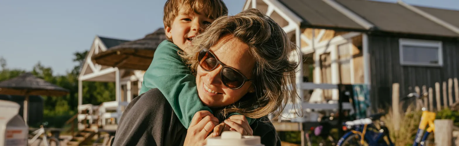 Kind en moeder strandhuisjes knuffel 1